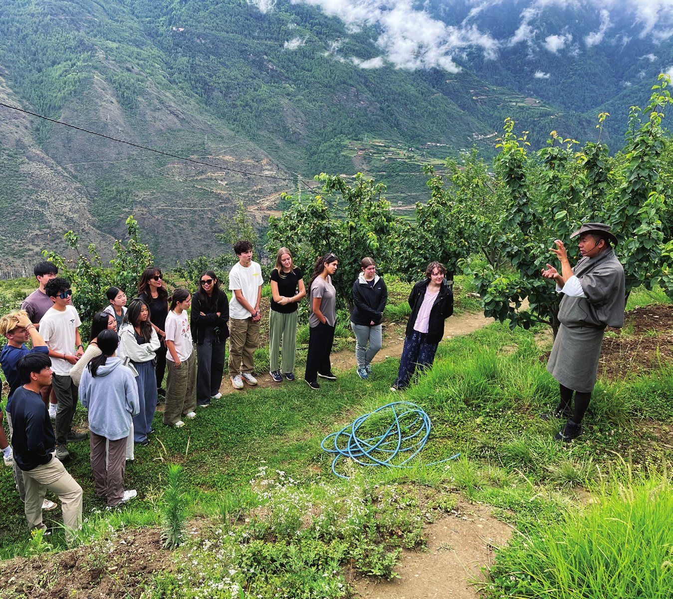Guests on a guided farm tour through the orchard at The Happiness Farm, Paro