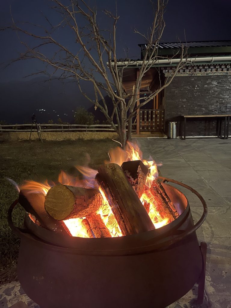 A bonfire burning in the courtyard at night