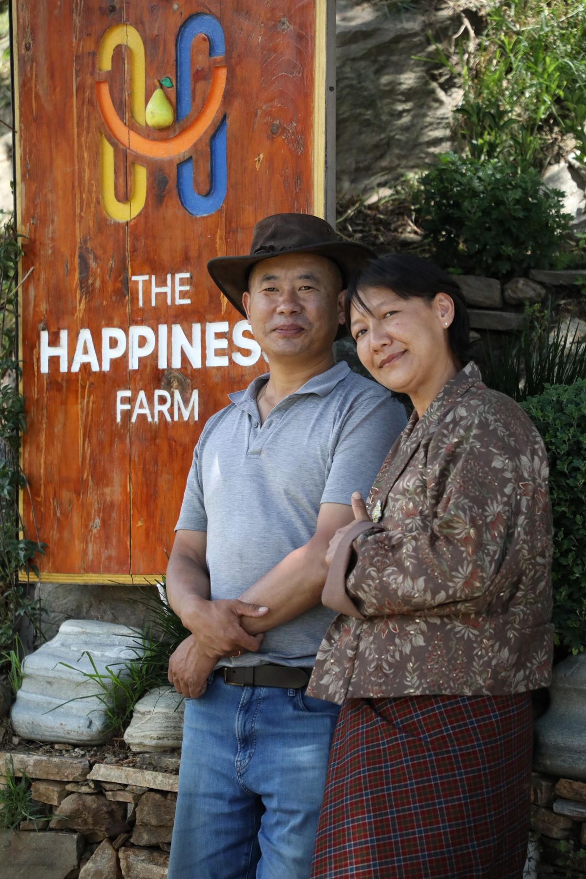 Your hosts beside The Happiness Farm sign